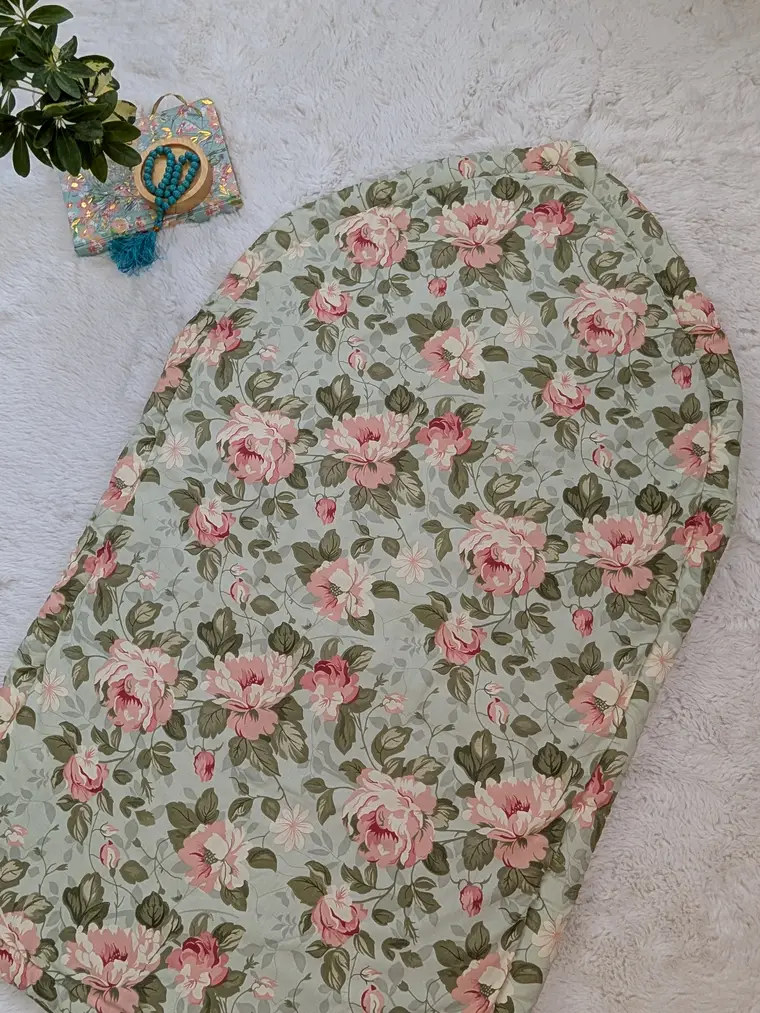 Rose floral quilted prayer mat on a soft white rug